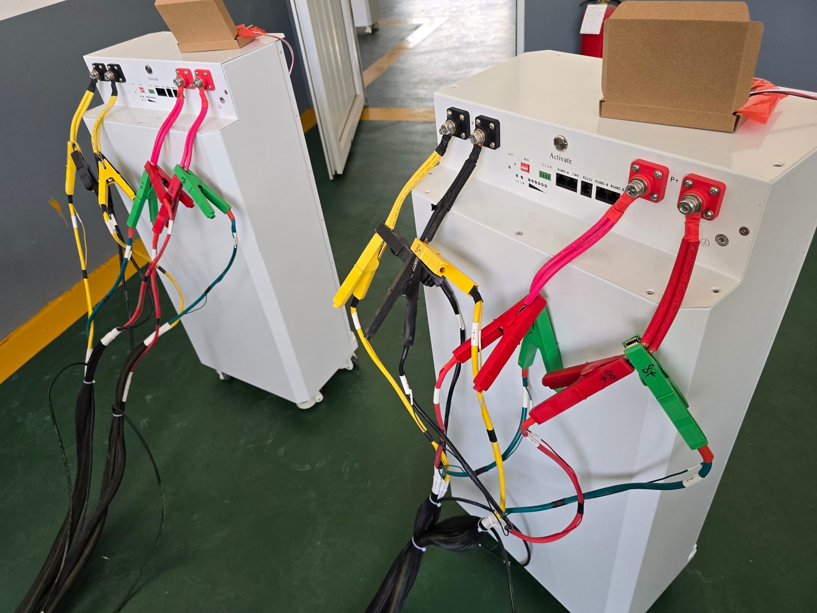 An open gray protective storage case on wheels, with latches and handles